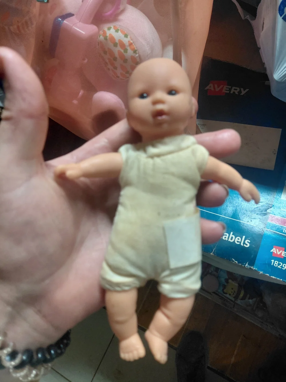 a vintage 1997 Corolle mini baby doll featuring blue eyes and a soft body.